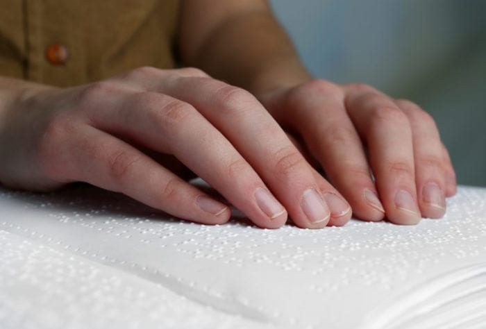 photo of person reading braille