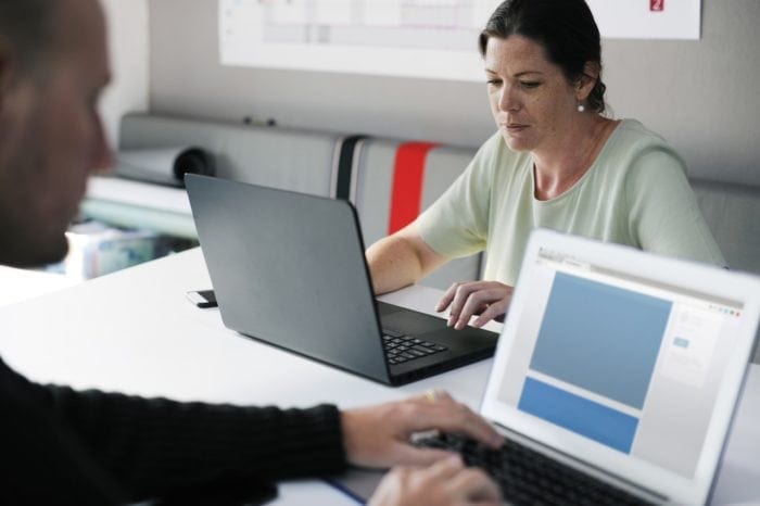 two staff members scanning content for web accessibility