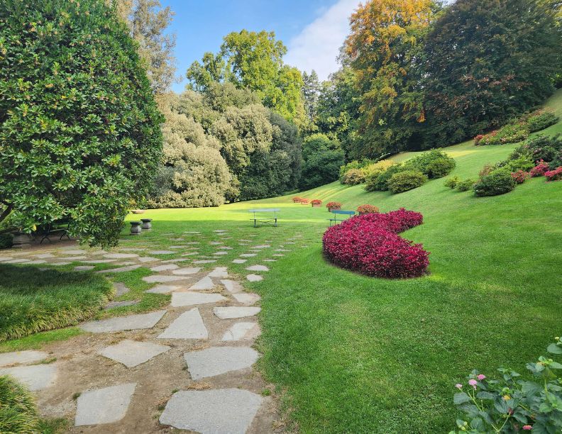 December 2027, Lush, green garden with a cobblestone walkway