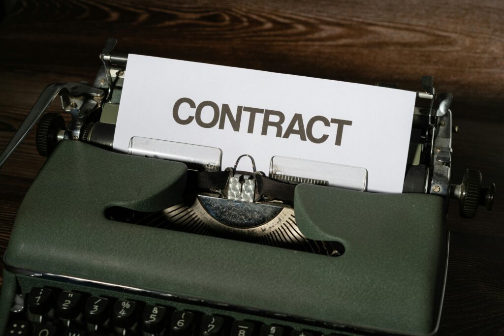 Typewriter with a sheet of paper that says "Contract"